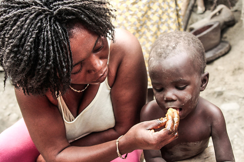 Ghanaian mother feeds her child.