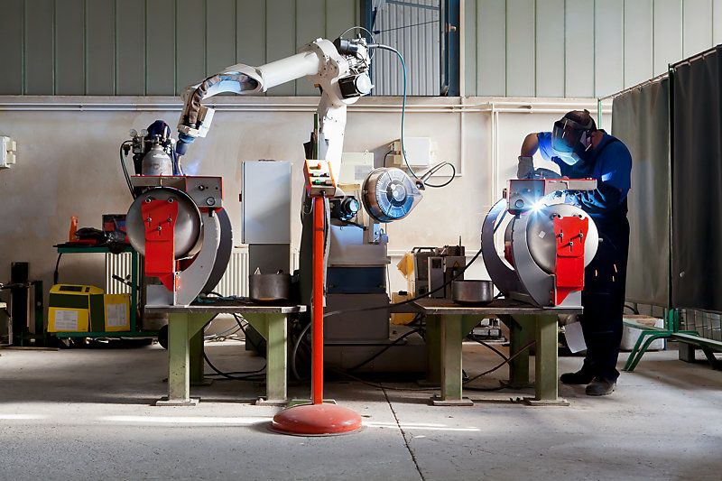 Man and robotic machine working together. 