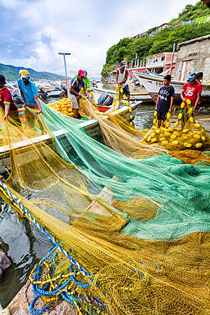 Fishermen preparing nets and boats for fishing in Venezuela.