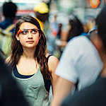 Teenage girl wearing Google Glasses, on Times Square.