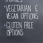Close-up of slate notice board advertising “vegetarian and vegan options”.